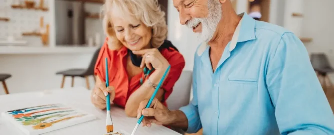 Senior couple painting together one of the activities to combat sundowning at The Village Senior Living in Tacoma, WA