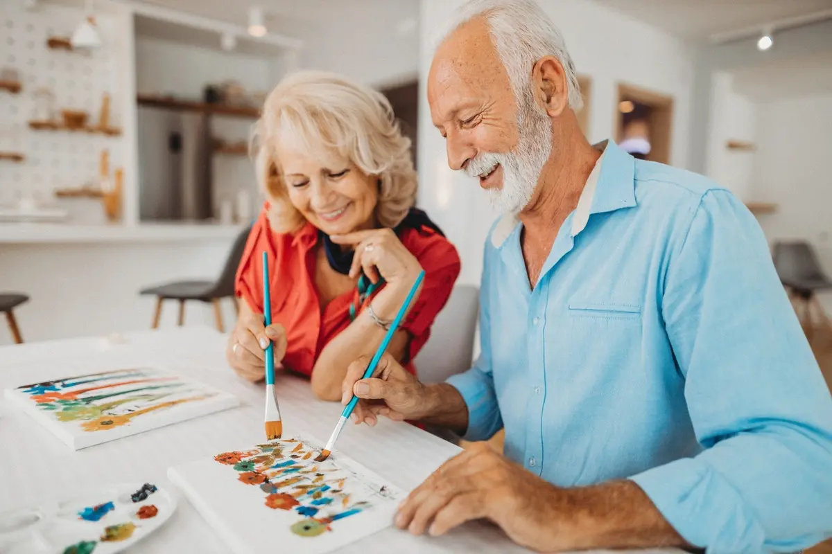Senior couple painting together one of the activities to combat sundowning at The Village Senior Living in Tacoma, WA