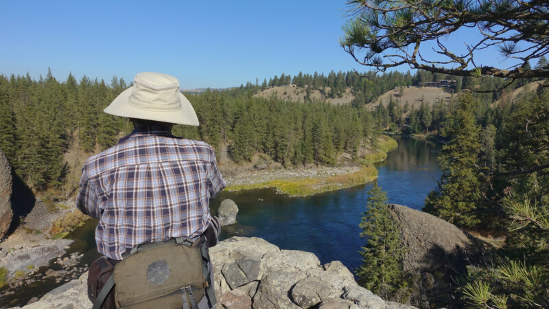 Senior with sun hat and long sleeve shirt enjoying pacific northwest summer using summer safety tips for seniors